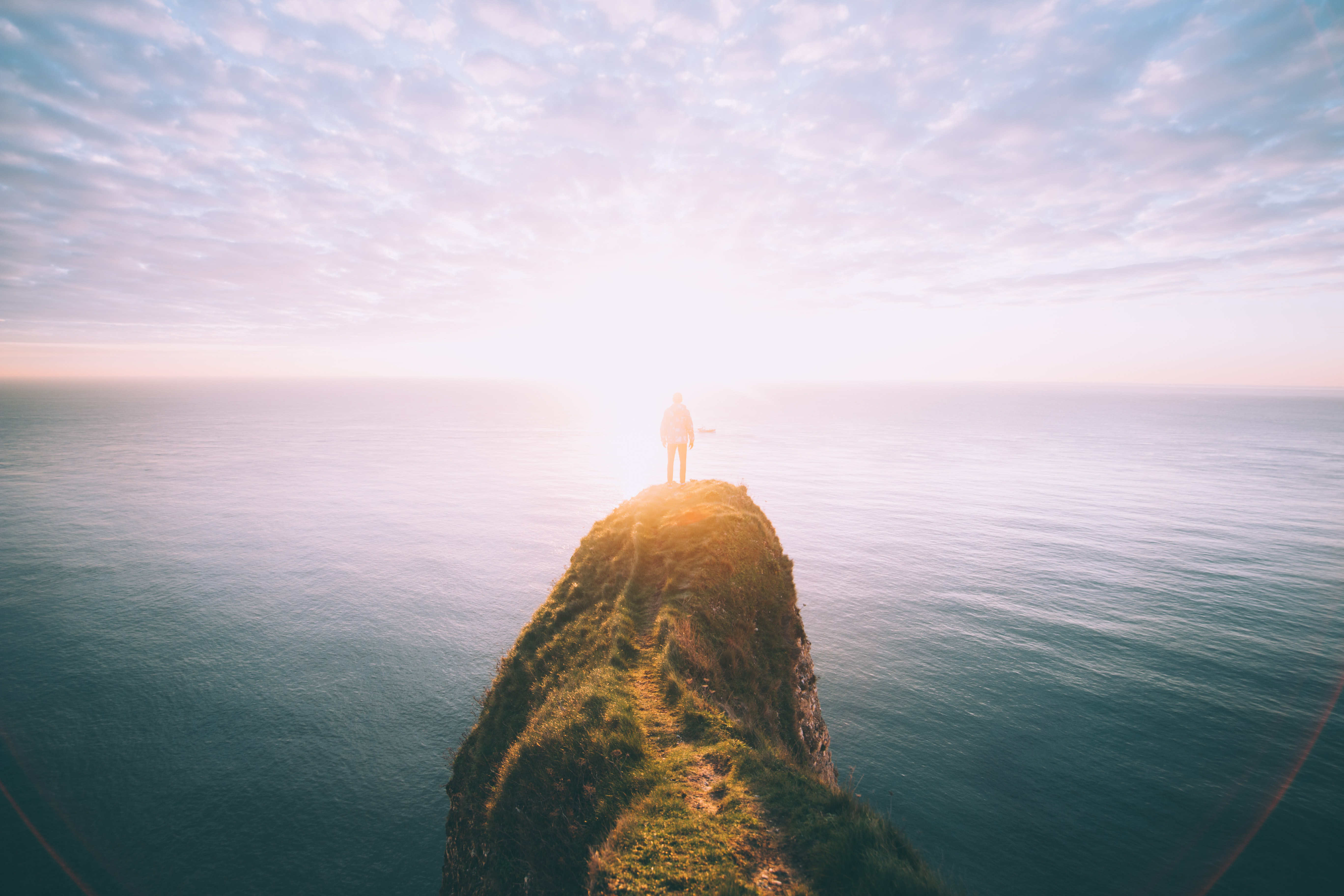 Person on top of the cliff, by Will van Wingerden on Unsplash